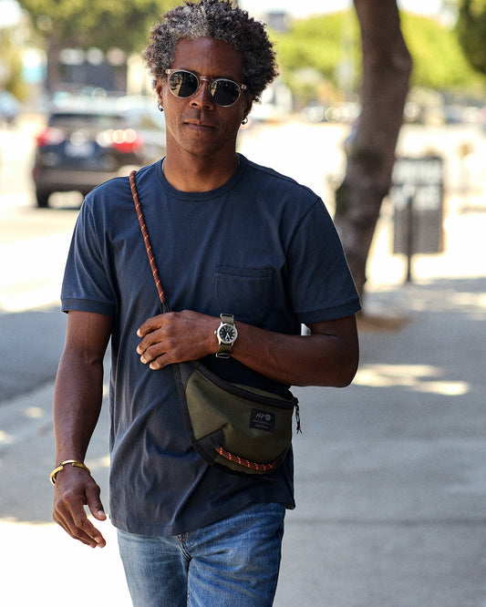 Man wearing navy blue crew neck shirt with a front chest pocket