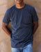 Man wearing navy blue crew neck shirt with a front chest pocket