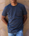 Man wearing navy blue crew neck shirt with a front chest pocket