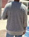 Man wearing gray crew neck sweater made from a blend of organic cotton and recycled polyester.