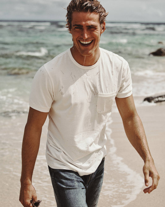 Man on the beach wearing plain white t-shirt
