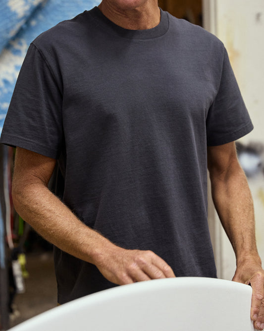 Closeup of man wearing black short sleeve t-shirt