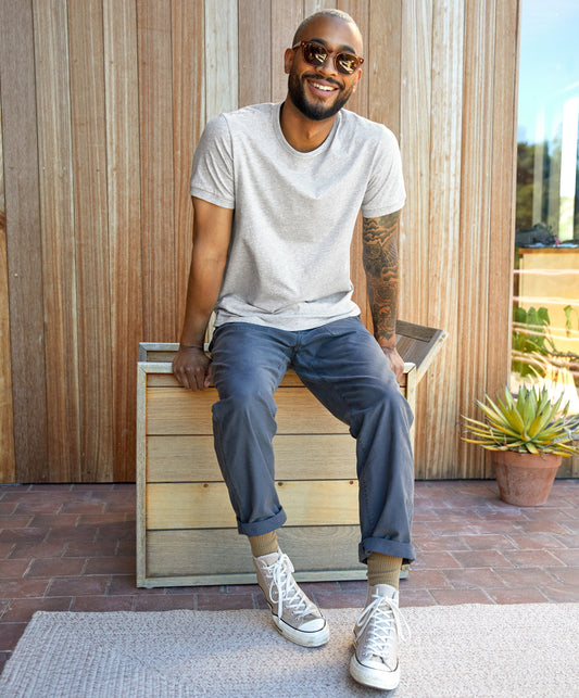 Man wearing a gray Sojourn tee by Outerknown, a men's short-sleeved t-shirt made with Peruvian Pima cotton.