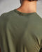 Back side of a man wearing a green crew-neck t-shirt