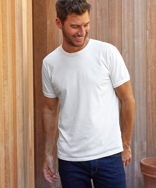 A plain white t-shirt on a man with a wood background