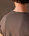 A brown crew-neck t-shirt with a front pocket, made from Peruvian Pima cotton.