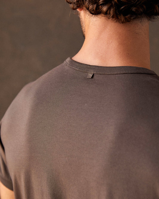 A brown crew-neck t-shirt with a front pocket, made from Peruvian Pima cotton.