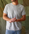 A gray Sojourn Pocket Tee with a front pocket, short sleeves, and a round neckline.