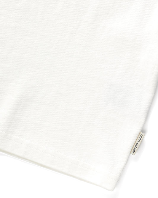 Close up of 'Outerknown' tag on seem of white short-sleeved t-shirt