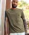 Model wearing the olive OK Dot Pocket Tee with a logo patch pocket