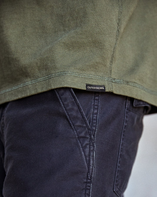 Hemline of olive green long-sleeved henley t-shirt