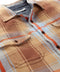 Close-up of plaid blanket shirt with point collar and dark button placket