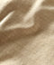 Closeup of materials of beige utilitarian shirt
