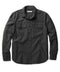 A long-sleeved black shirt with a herringbone texture, featuring a collar, button-up front, and two chest pockets.