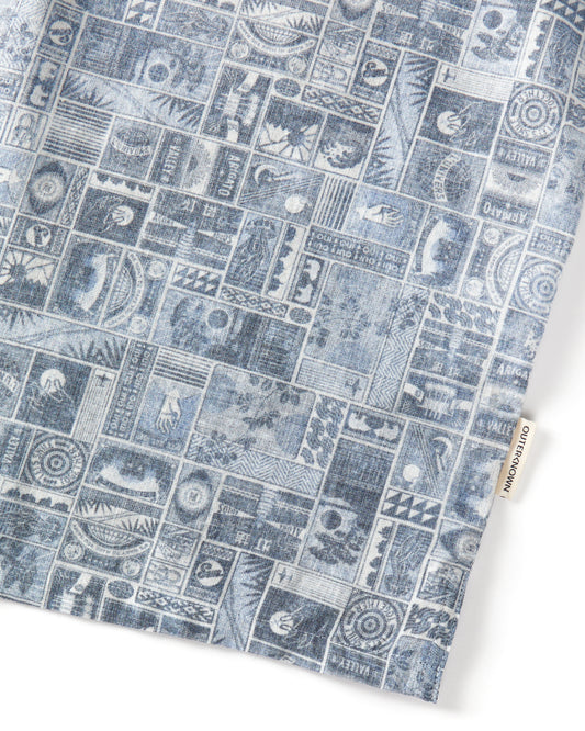 Closeup of blue patterned button down on a white background