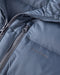 Storm blue hooded puffer jacket front zipper and logo patch close-up