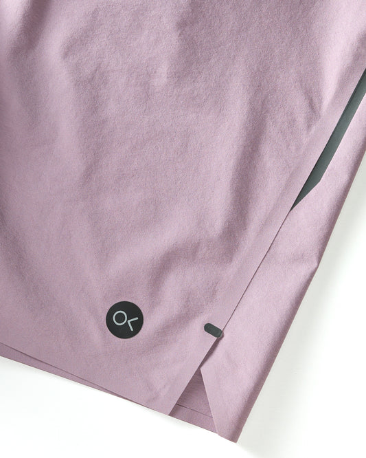Closeup of logo on purple boardshorts