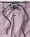 Closeup of drawstring on purple boardshorts