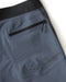 Closeup of back pocket of blue boardshorts
