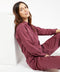 Outerworn plum station jumpsuit, zip front, long sleeves, and adjustable drawcord waist