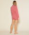 Outerworn Wander romper back view, mineral red, long sleeves, drawstring waist.