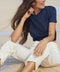 Marine blue linen crew-neck tee with short sleeves, knotted front hem