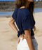 Marine blue linen tee with short sleeves, tied at the waist, back view