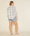 Back view of a gray and white plaid shirt with a curved hem.