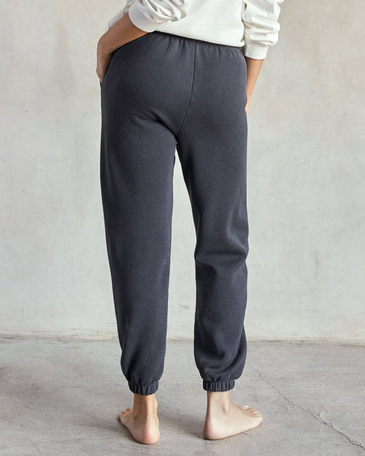 woman wearing sweatpants, facing the back.