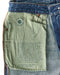 Indigo denim jeans care label inside back pocket, stitched canvas patch