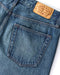 Light indigo denim jeans with front patch pocket and leather logo label
