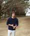 Indigo crewneck sweater on model with long sleeves and ribbed hem