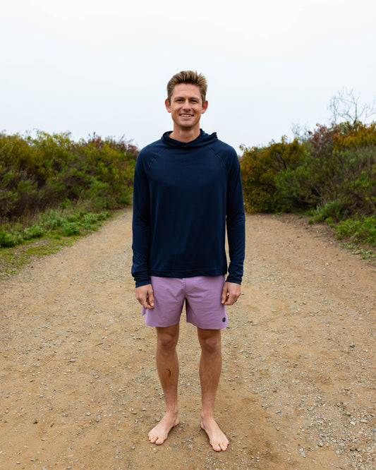 Man wearing purple boardshorts on the beach