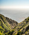 Coastal hillside landscape accompanying the OK Dot Pocket Tee listing