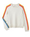 Beige sweater with rainbow stripes on sleeves against a white background