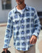 Closeup of man wearing a blue and white plaid blanket shirt.