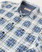 Closeup of blue and white plaid blanket shirt.