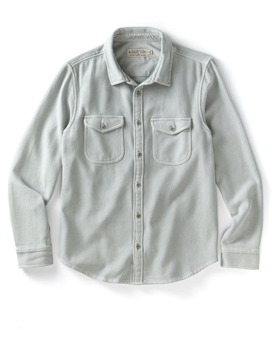 Light gray blanket shirt with two front pockets on a white background