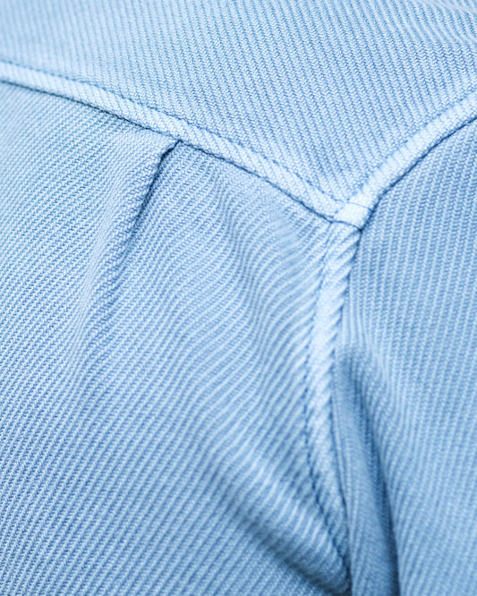 Close-up of a light blue fabric with stitching detail