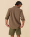 Back view of olive-brown blanket shirt with relaxed fit and buttoned cuffs