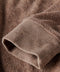 Close-up of brown textured fabric with a focus on texture and color.