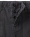 Close-up of dark gray pants with button details