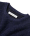 Indigo crewneck sweater neckline with embroidered brand label